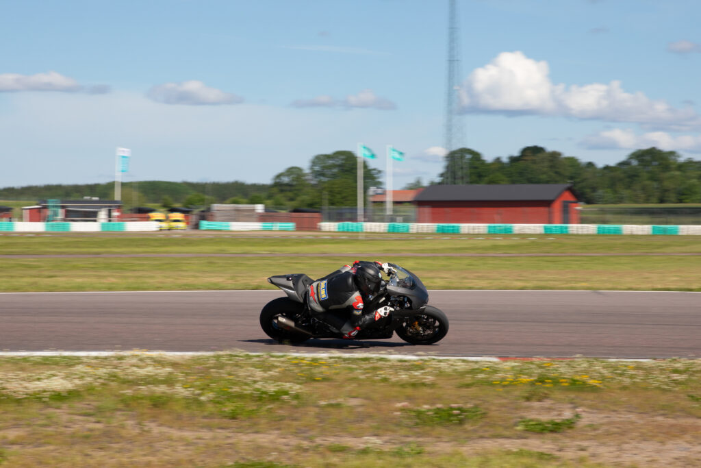 a motorcycle rides on a racing track