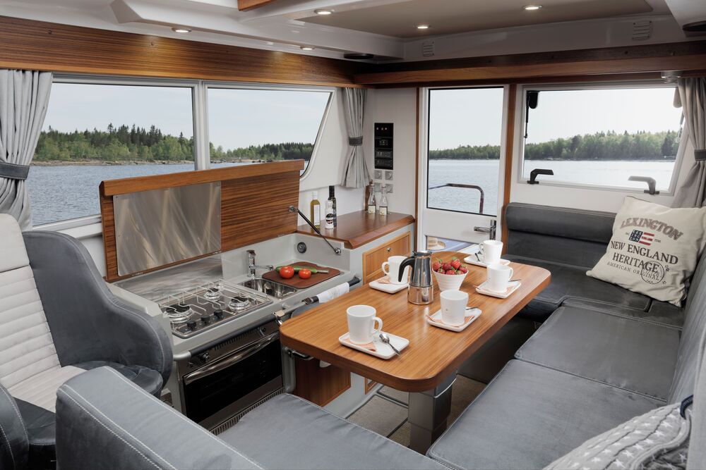 A boat interior showing a kitchen area with seating and cooking facilities, highlighting Lesjöfors’ marine-grade components in real-world applications.