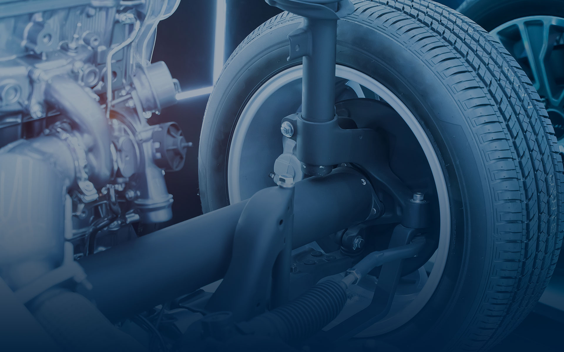 Automotive suspension and wheel assembly showing structural components commonly supported by stamped metal parts.