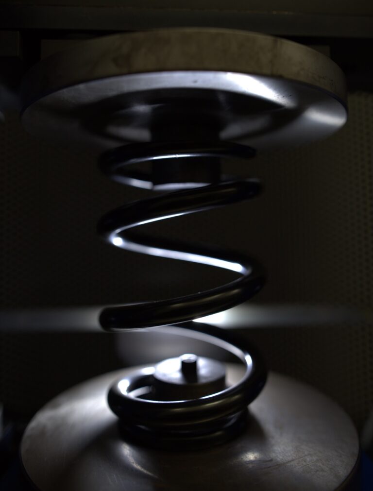 A pre-stresser used during spring manufacturing to improve a spring's performance and lifespan.