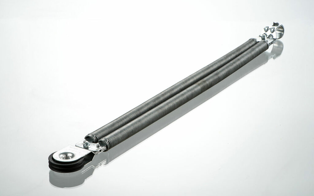 a garage door tension spring on a white shiny background